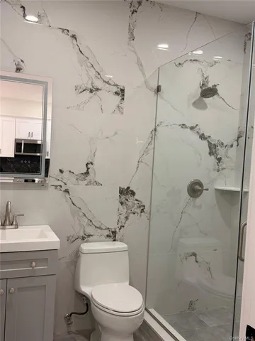 a bathroom with a sink toilet and shower