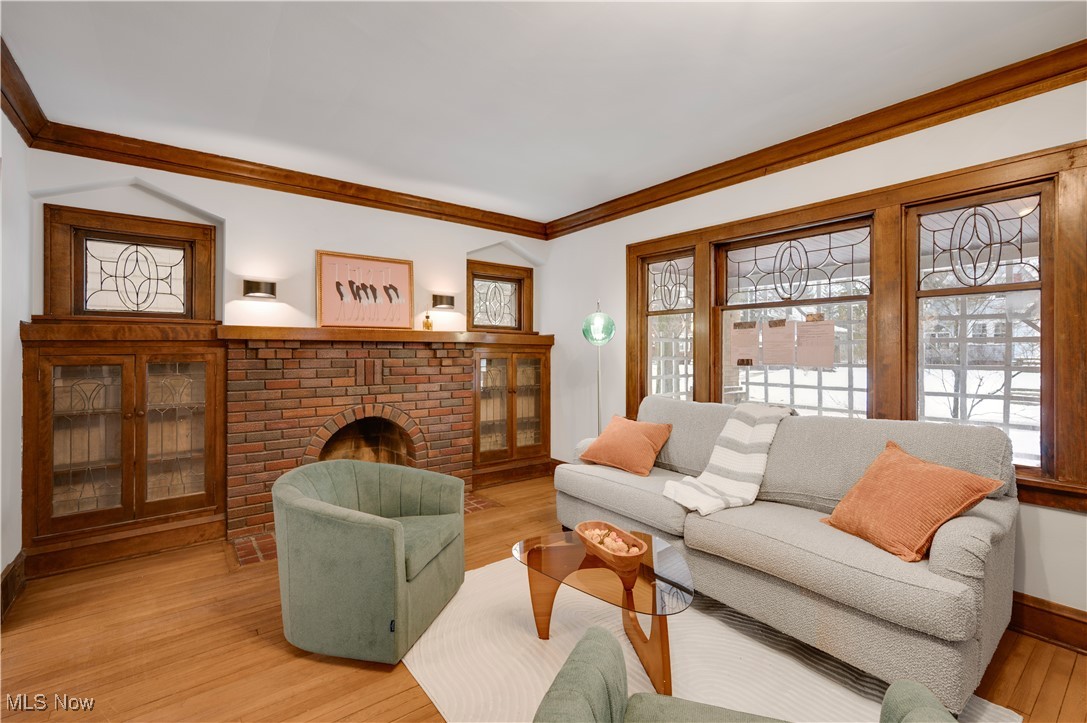 2016 Rossmoor Road Cleveland Heights, OH 44118 - Photo 10 of 46 Living area featuring crown molding, a fireplace, and wood finished floors