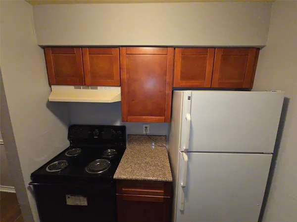 a kitchen with a refrigerator and a sink
