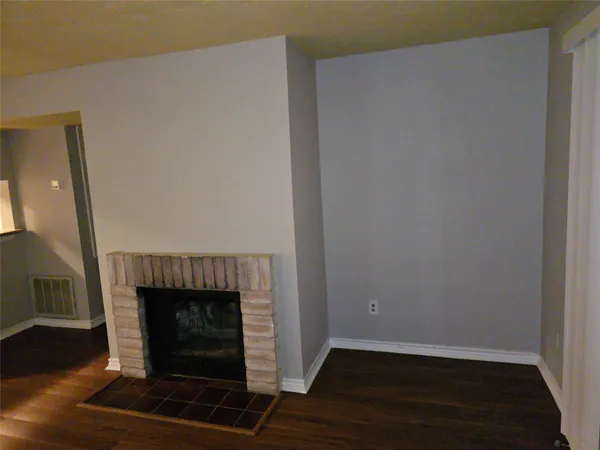 a room with a fireplace and wooden floor