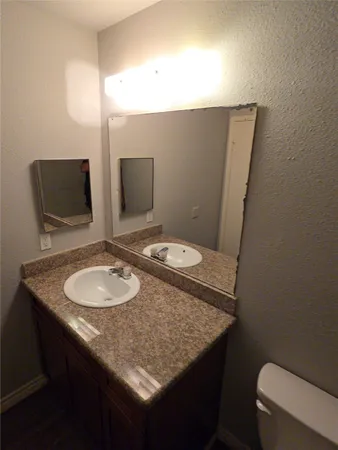 a bathroom with a sink and a large mirror