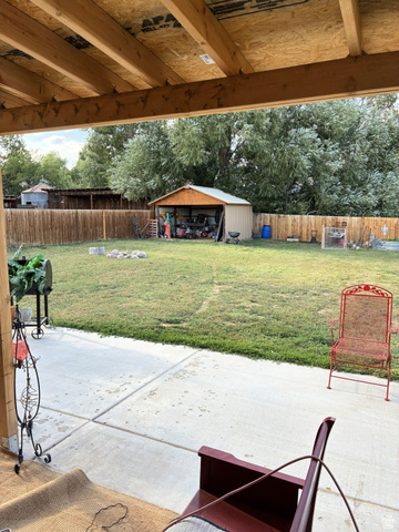547 East 2000th Street North Vernal, UT 84078 - Photo 45 of 50 Covered patio with concrete flooring, overlooking a green lawn