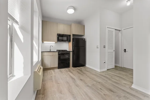 a kitchen with stainless steel appliances a refrigerator and a sink