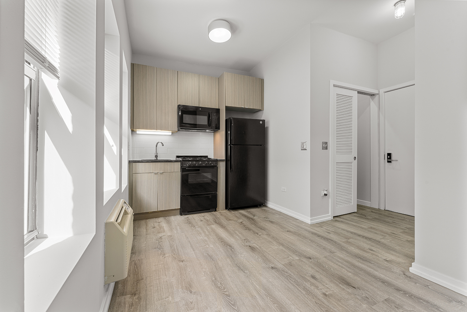 4875 North Magnolia Avenue, Unit 311 Chicago, IL 60640 - Photo 3 of 8 a kitchen with stainless steel appliances a refrigerator and a sink