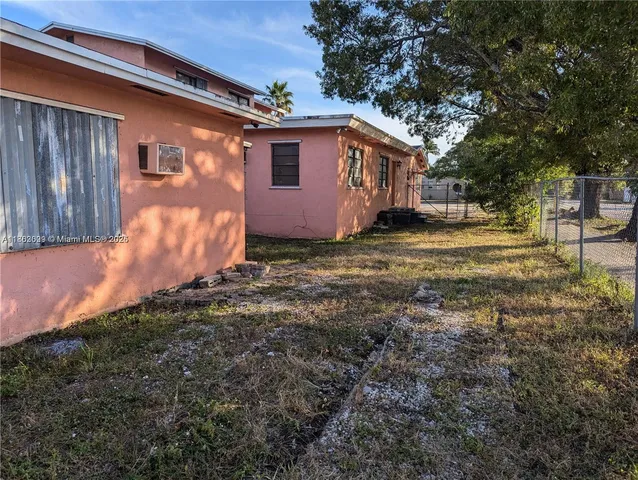 a view of a backyard with large tree