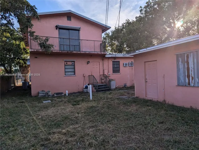 a backyard of a house with table and chairs
