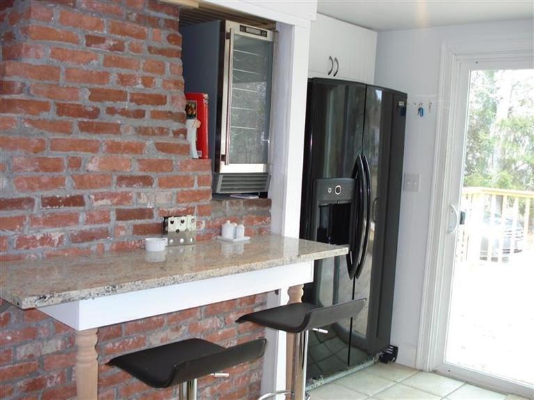 60 Elliott Road Centerville, MA 02632 - Photo 11 of 22 a kitchen with a refrigerator and a sink