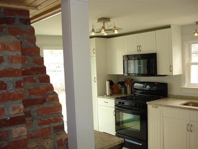 60 Elliott Road Centerville, MA 02632 - Photo 13 of 22 a kitchen with a stove and a microwave