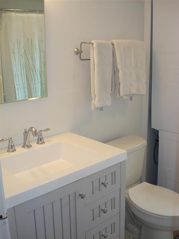 60 Elliott Road Centerville, MA 02632 - Photo 20 of 22 a bathroom with a sink toilet vanity and tub