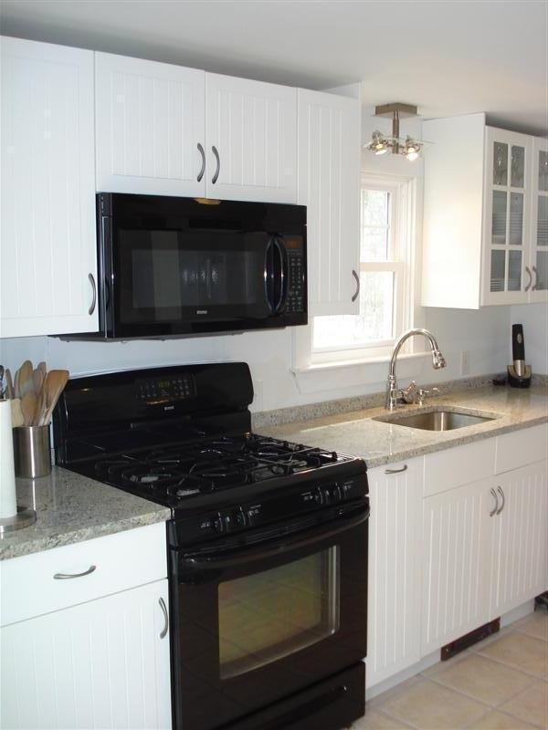60 Elliott Road Centerville, MA 02632 - Photo 7 of 22 a kitchen with granite countertop a stove and a sink