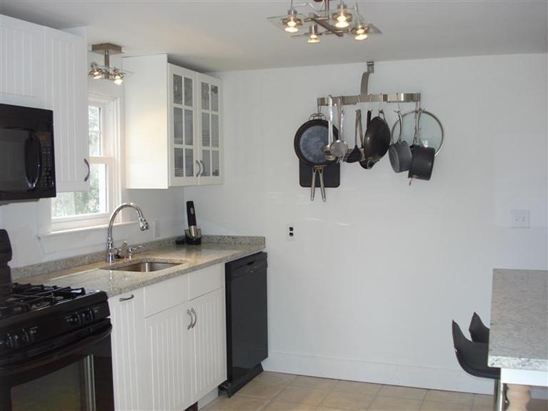 60 Elliott Road Centerville, MA 02632 - Photo 8 of 22 a kitchen with a sink dishwasher a stove and a microwave oven