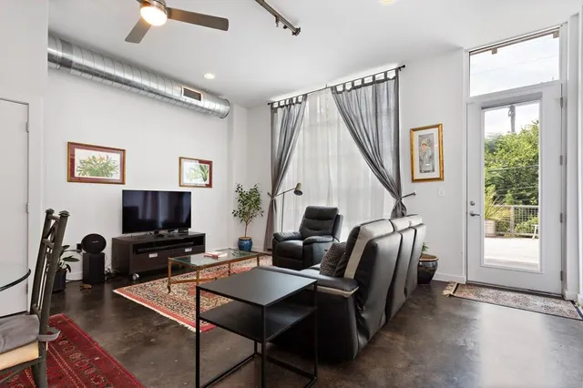 a work room with furniture and a flat screen tv