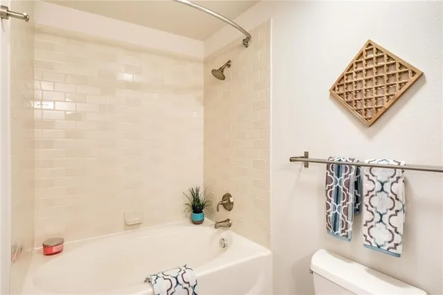 a bathroom with a bathtub and shower