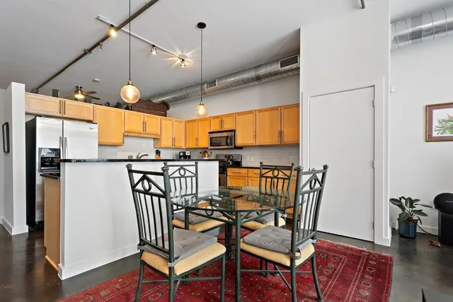 a view of a kitchen with dining table and chairs
