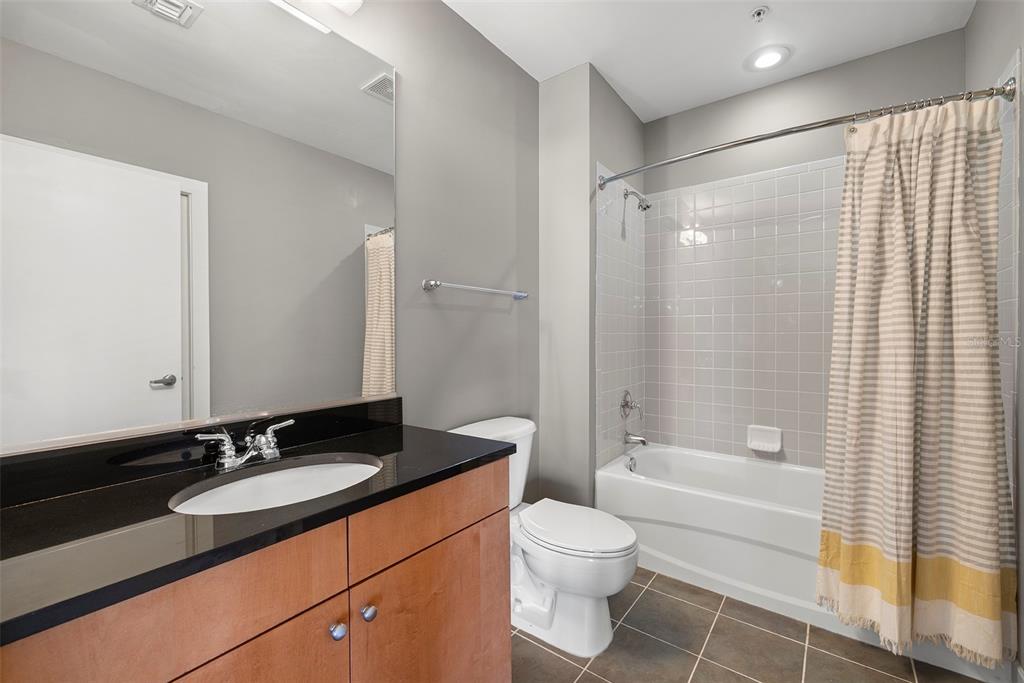 1010 Central Avenue, Unit 302 St. Petersburg, FL 33705 - Photo 18 of 50 a bathroom with a granite countertop sink toilet and shower
