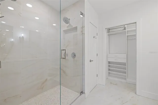 a view of walk in closet with empty racks