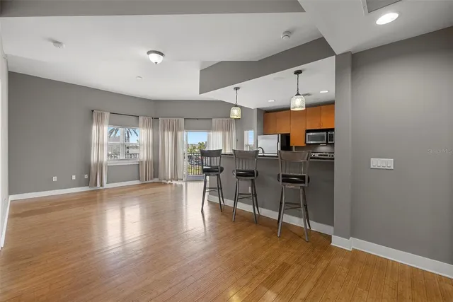 a view of a kitchen with dining table and chairs