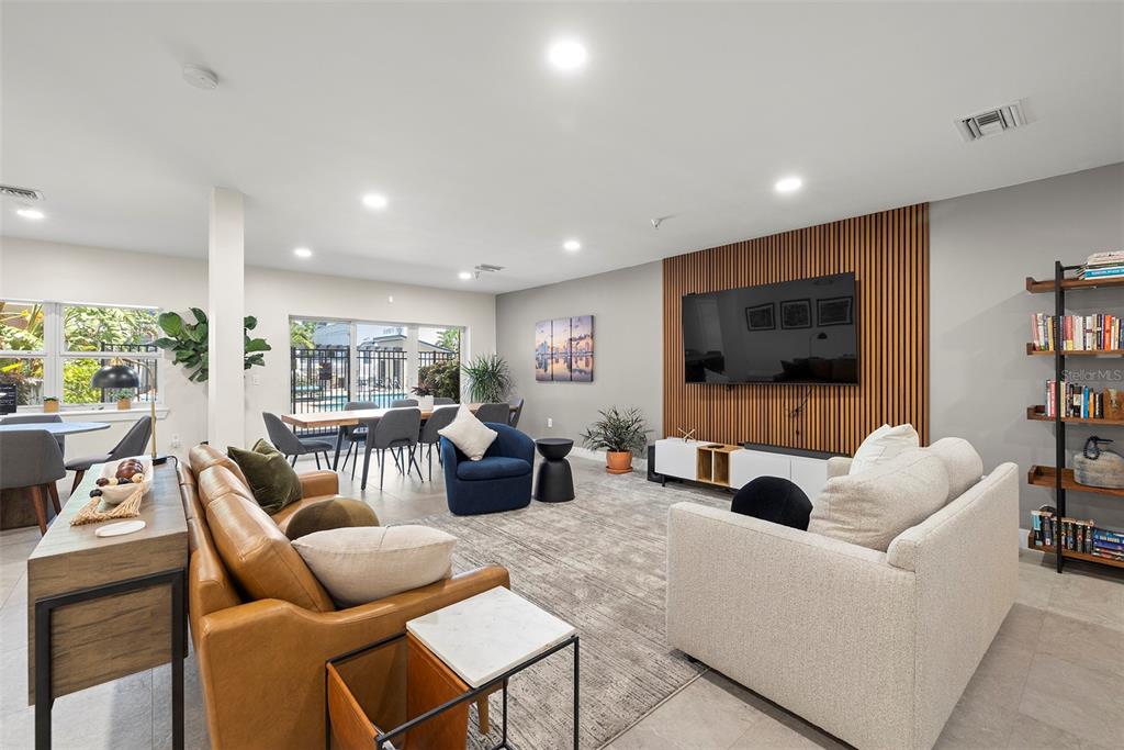 1010 Central Avenue, Unit 302 St. Petersburg, FL 33705 - Photo 45 of 50 a living room with furniture and a flat screen tv