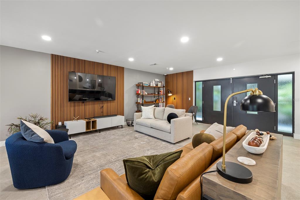 1010 Central Avenue, Unit 302 St. Petersburg, FL 33705 - Photo 47 of 50 a living room with furniture and a flat screen tv