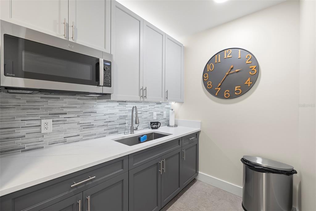 1010 Central Avenue, Unit 302 St. Petersburg, FL 33705 - Photo 49 of 50 a kitchen with a sink and a microwave