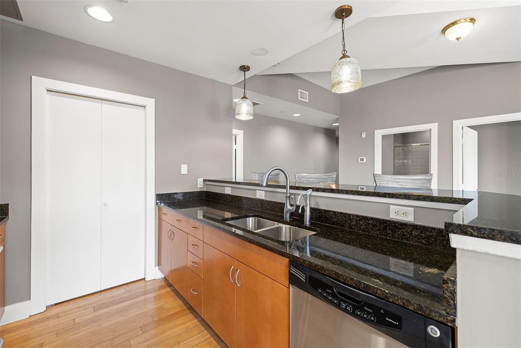 1010 Central Avenue, Unit 302 St. Petersburg, FL 33705 - Photo 9 of 50 a kitchen with stainless steel appliances granite countertop a sink and a stove