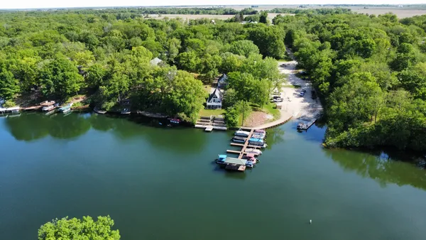 an aerial view of a house with a lake view
