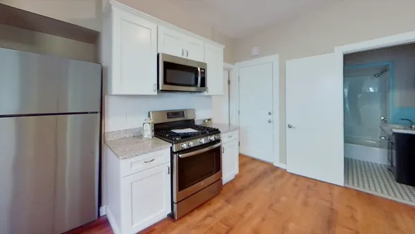 a kitchen with stainless steel appliances a refrigerator stove and microwave