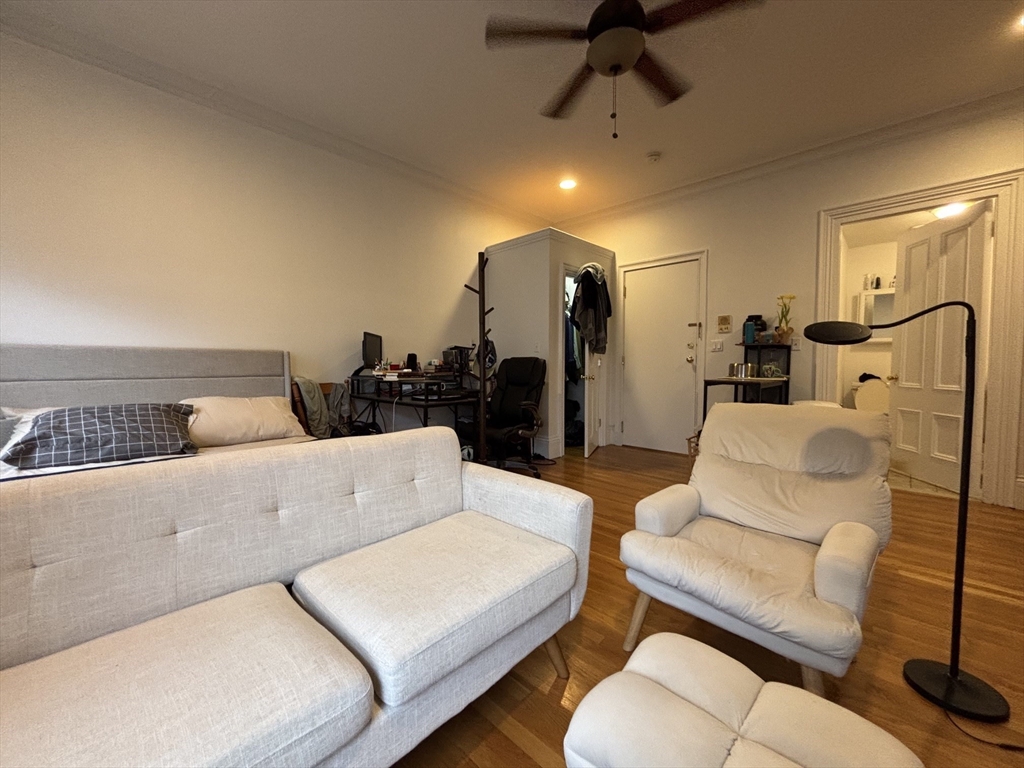 98 Charles Street, Unit 1 Boston, MA 02114 - Photo 2 of 9 a living room with furniture and a couch