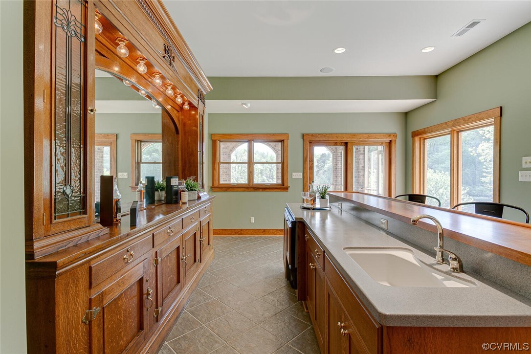 3535 Meadow Road Sandston, VA 23150 - Photo 34 of 50 a large kitchen with kitchen island a large window a sink and stainless steel appliances