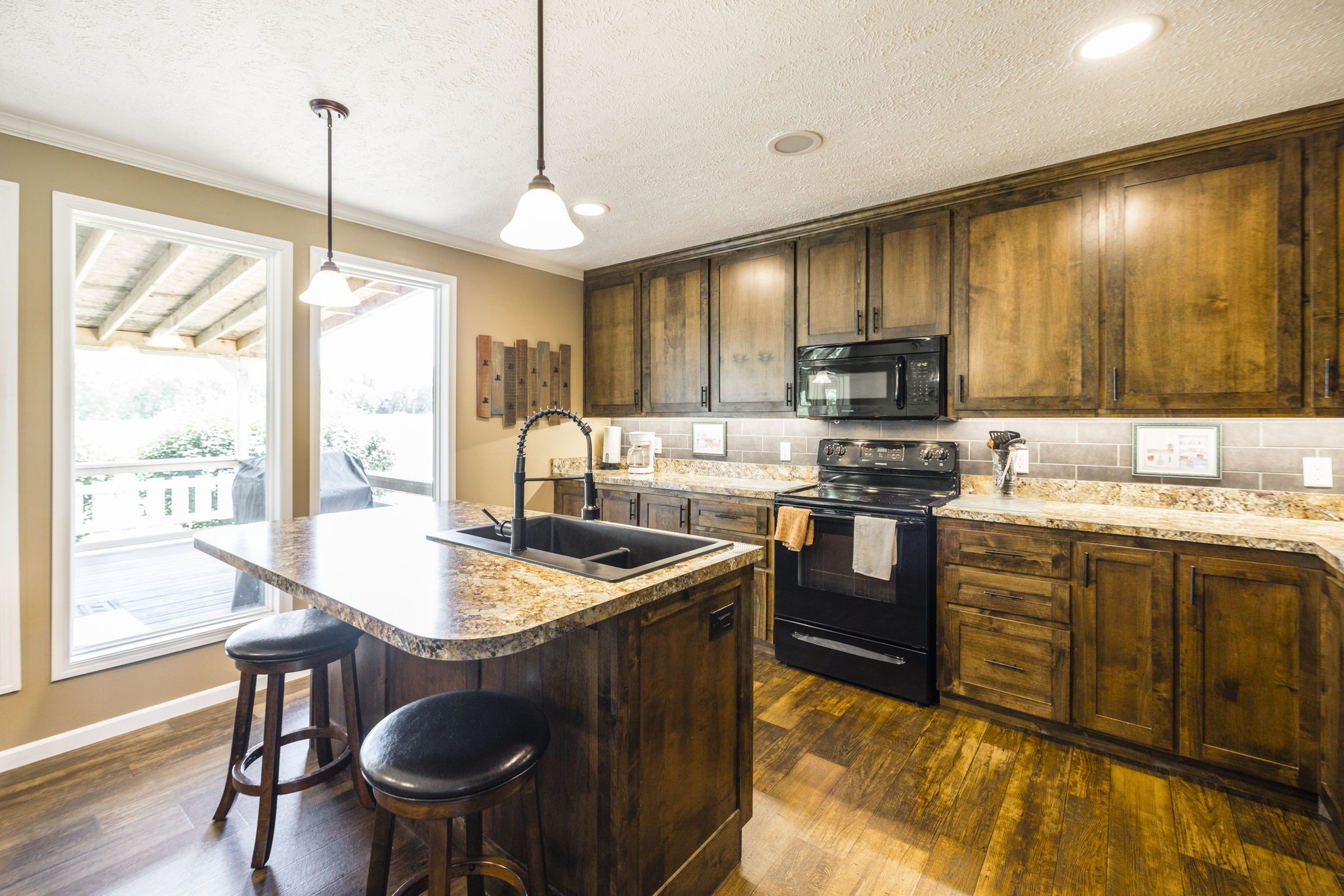 4265 Armstrong Road Springfield, TN 37172 - Photo 25 of 57 a kitchen with stainless steel appliances granite countertop sink stove and wooden cabinets