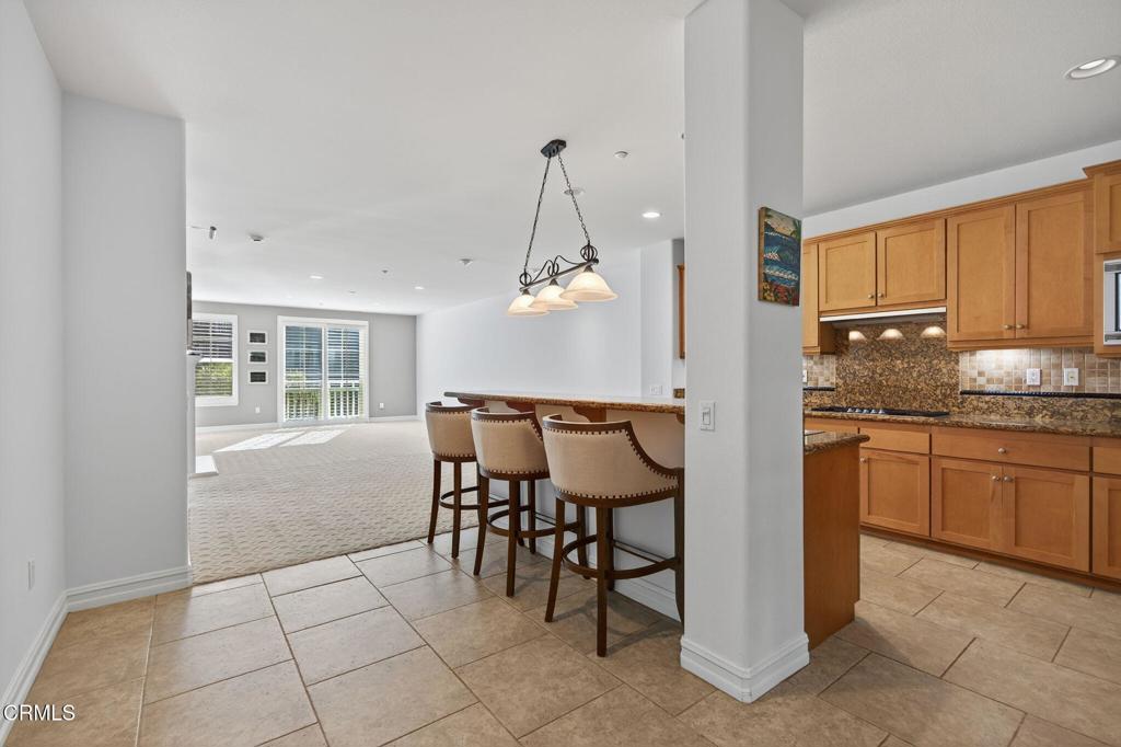 1423 Windshore Way Oxnard, CA 93035 - Photo 12 of 77 a kitchen with granite countertop cabinets and chairs