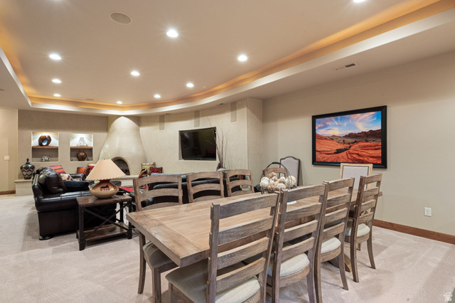 2331 West Entrada Trail, Unit 61 St. George, UT 84770 - Photo 39 of 69 Spacious entertainment area featuring a kiva fireplace, recessed lighting, and integrated wall shelving