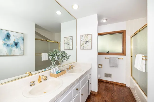 a bathroom with a tub sink and mirror