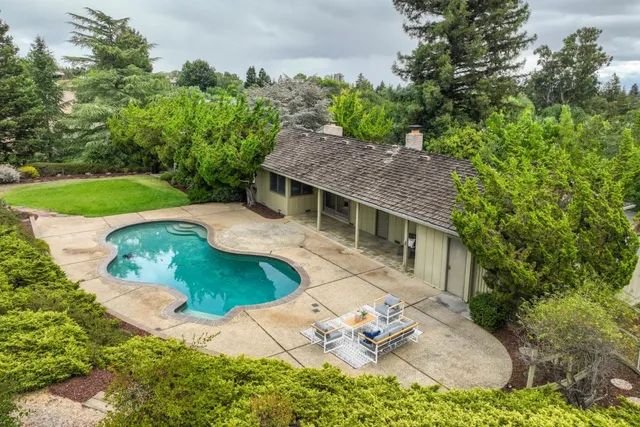 an aerial view of a house with outdoor space