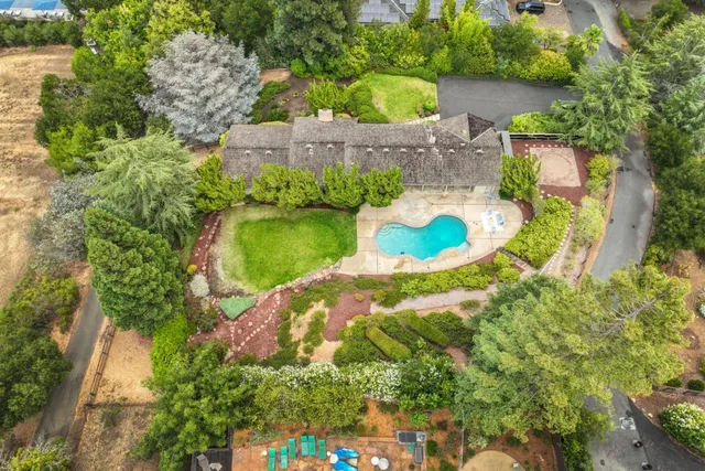 an aerial view of a house with outdoor space swimming pool and lake view