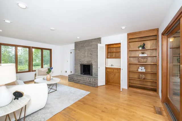 a living room with furniture hardwood floor and a fireplace