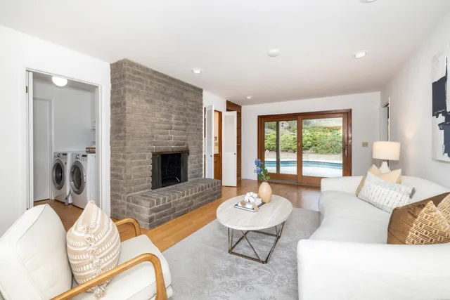 a living room with furniture and a fireplace