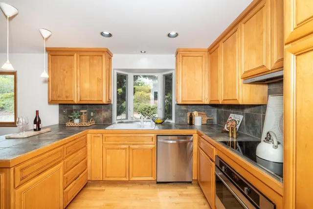 a kitchen with a sink and wooden cabinets