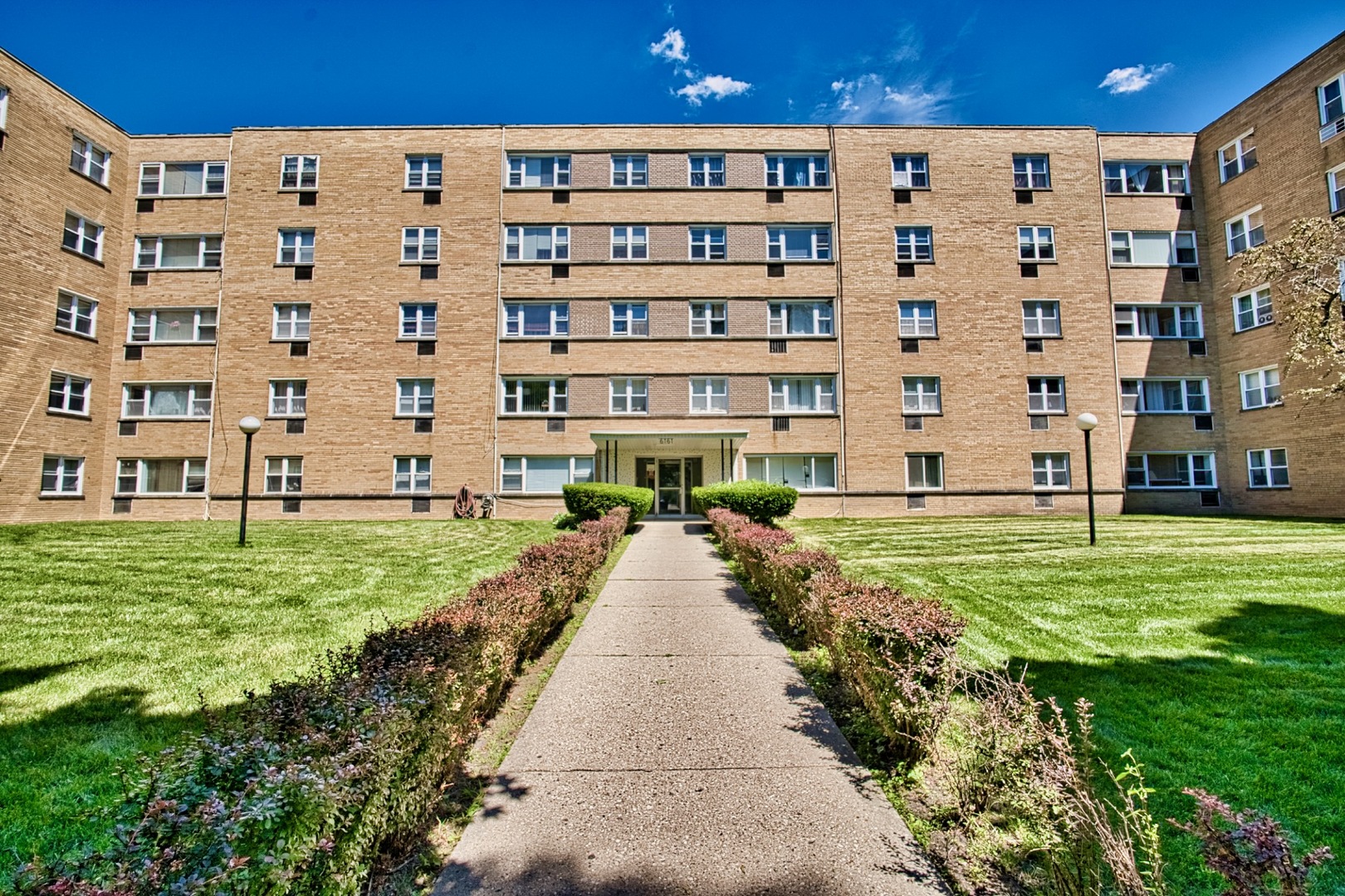 a view of an apartment with a garden