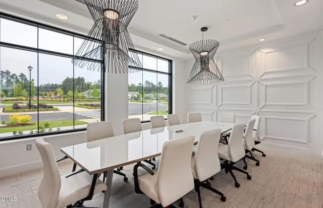 a view of a dining room with furniture wooden floor and chandelier