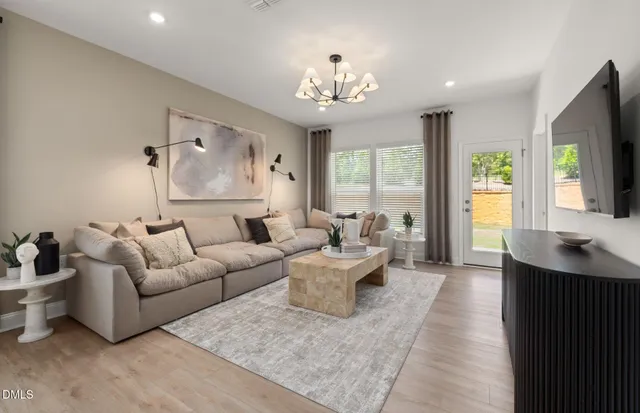 a living room with furniture and kitchen view