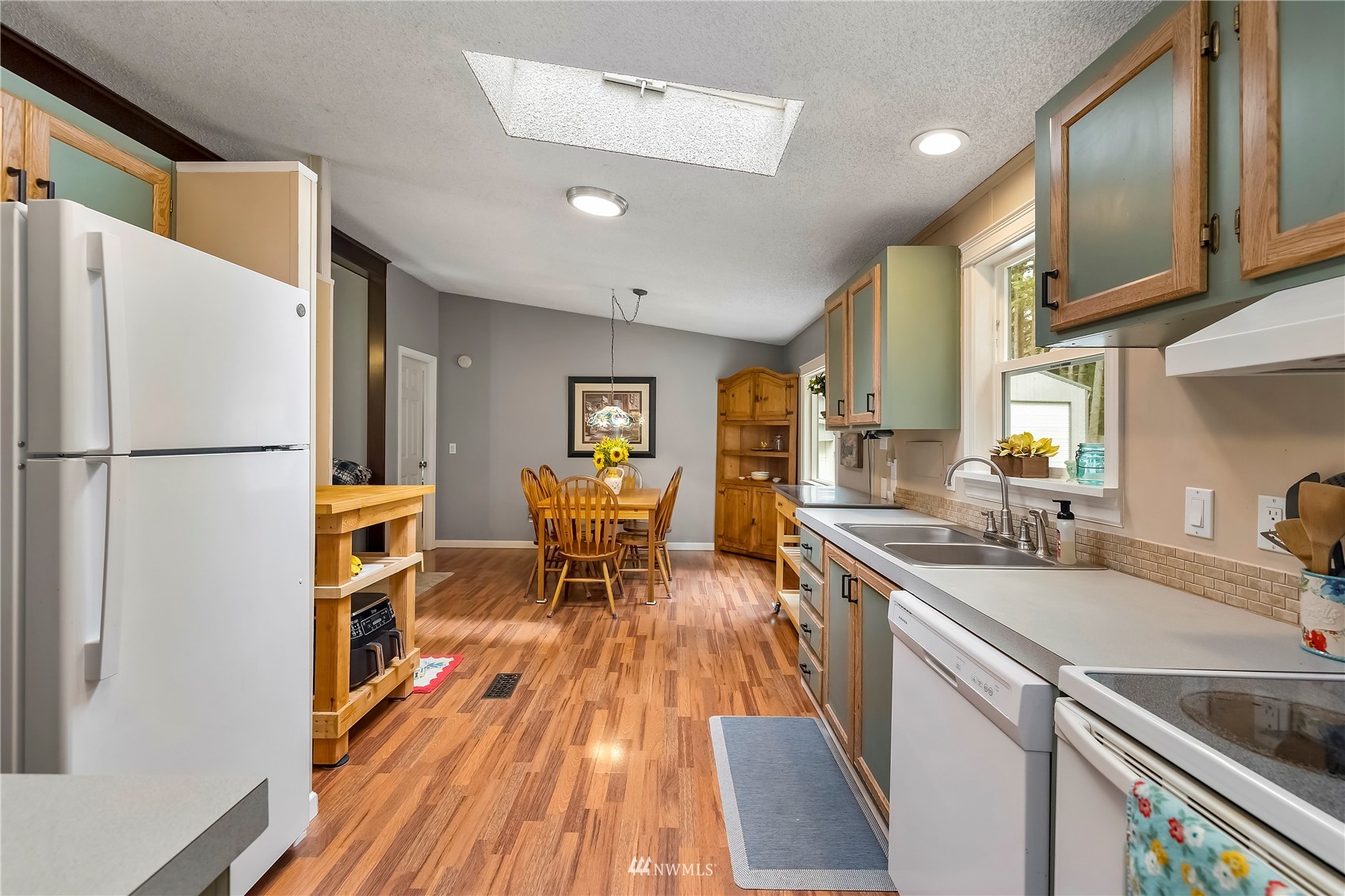 16820 Littlerock Road Southwest Rochester, WA 98579 - Photo 23 of 33 a kitchen with granite countertop a sink appliances and cabinets
