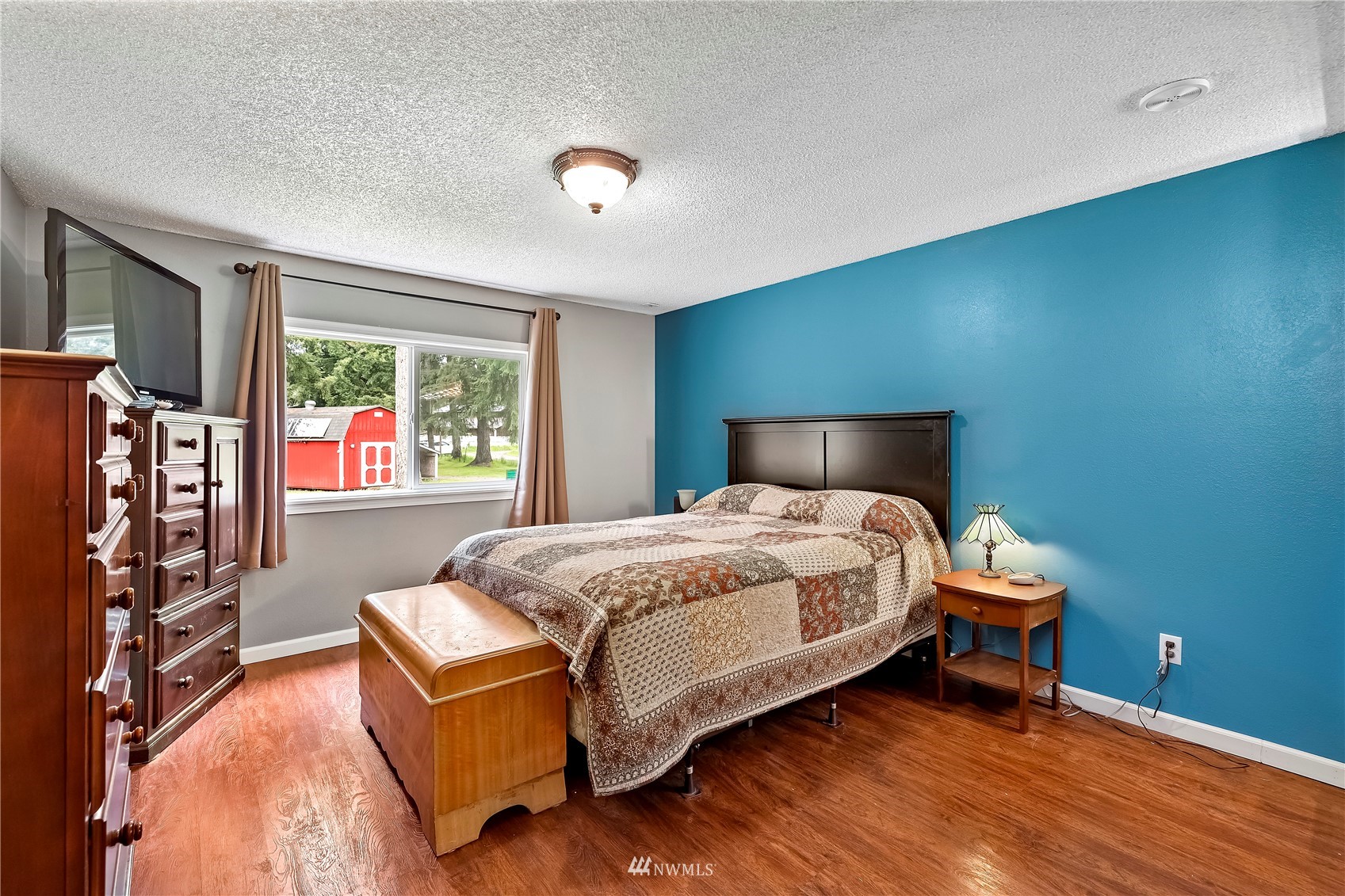 16820 Littlerock Road Southwest Rochester, WA 98579 - Photo 25 of 33 a bedroom with a bed and wooden floor