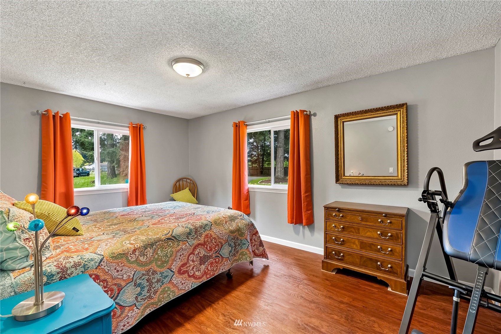 16820 Littlerock Road Southwest Rochester, WA 98579 - Photo 28 of 33 a bedroom with a bed and wooden floor
