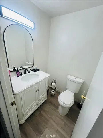a white toilet sitting next to a bathroom sink
