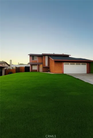a view of building with garden and trees in the background