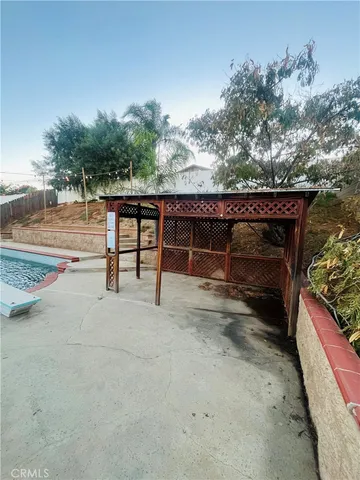 a view of backyard with deck and outdoor seating