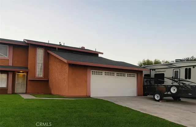 a car parked in front of a house with wooden fence