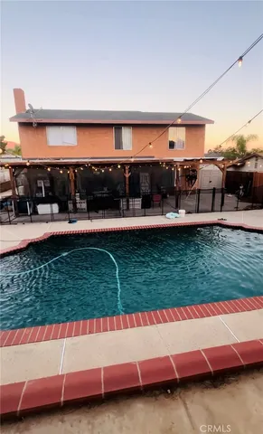 a view of swimming pool outdoor seating and yard