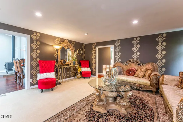 a living room with furniture and a gym machine